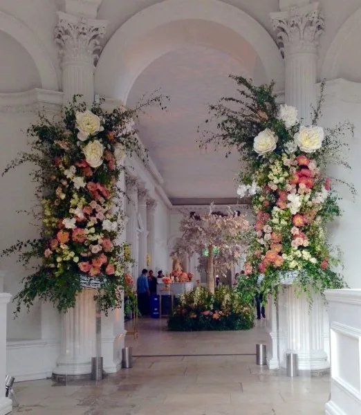 Two tall floral columns framing the entrance to a grand hall