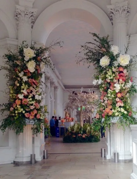 Two tall floral columns framing the entrance to a grand hall
