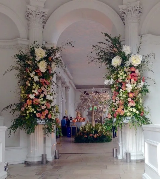 Two tall floral columns framing the entrance to a grand hall