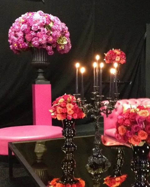 Hot pink arrangements and candelabra against black for a party